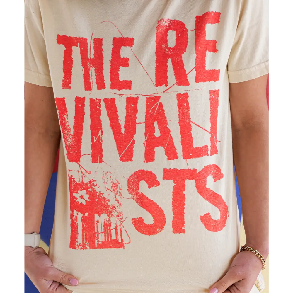 T-shirt with red text reading ’THE REVIVALISTS’ and a small graphic.