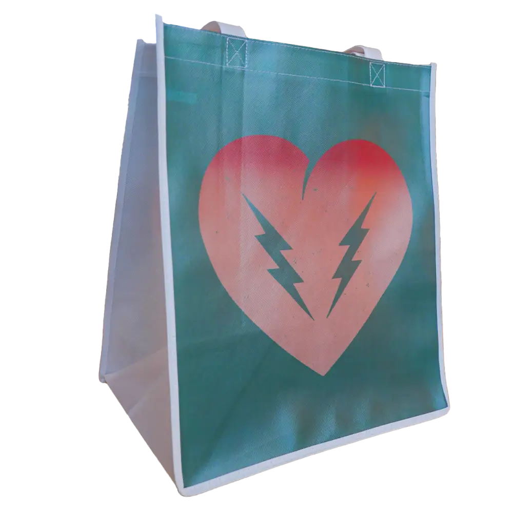 Teal shopping bag with a pink heart and lightning bolt design.