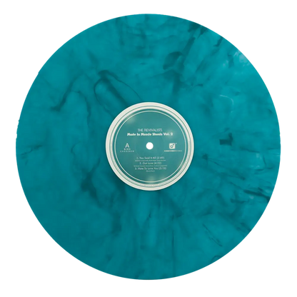 Turquoise marbled vinyl record with a white and green label in the center.