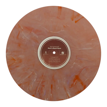 Marbled orange and white vinyl record with a brown label in the center.