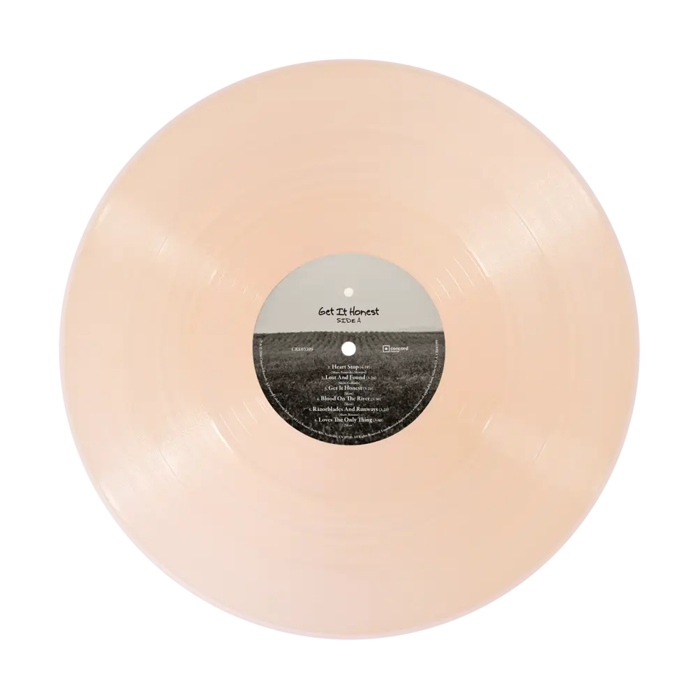 A translucent peach-colored honest vinyl record in limited edition crystal rose color with get it honest tracklist label