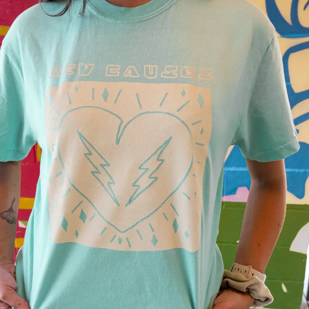 Mint green t-shirt with a white heart and lightning bolt design.