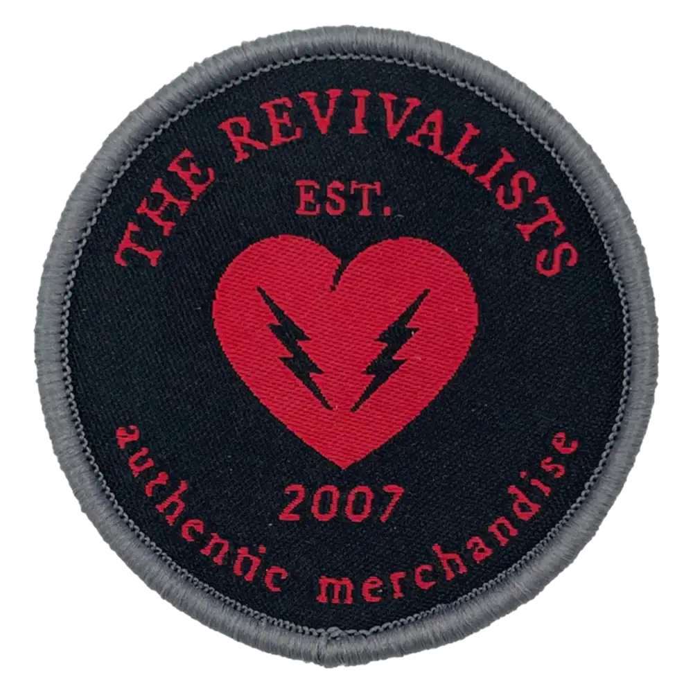 Circular embroidered patch featuring ’The Revivalists’ logo with a red heart and lightning bolts.