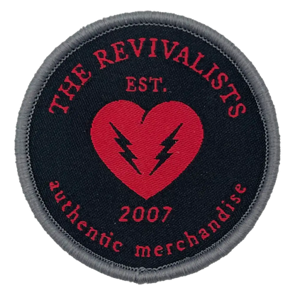 Circular embroidered patch featuring ’The Revivalists’ logo with a red heart and lightning bolts.