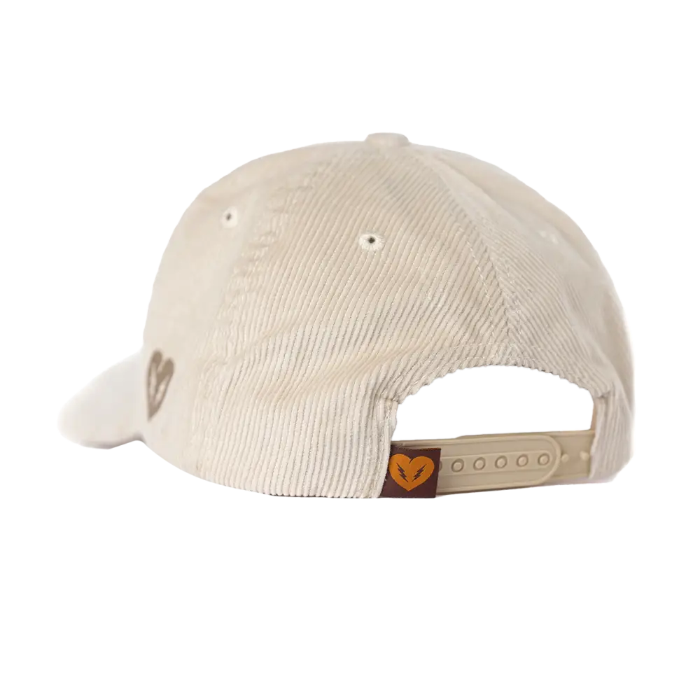 Beige corduroy baseball cap with an adjustable strap and small heart logo.